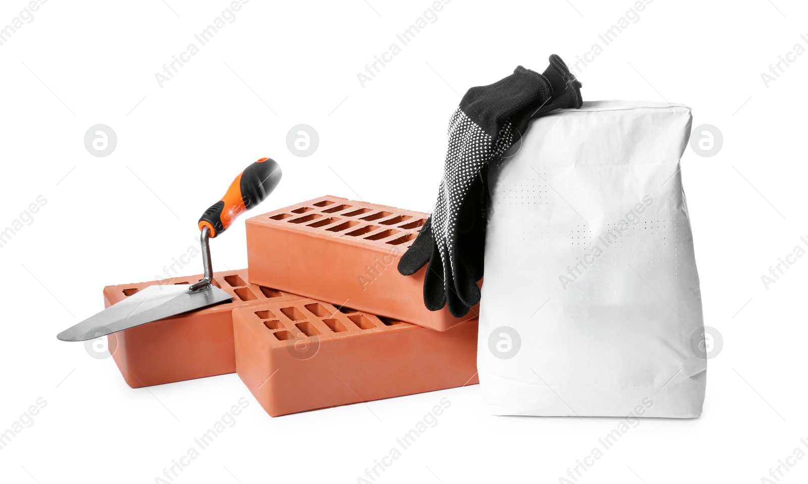 Photo of Red bricks, bag of cement, gloves and trowel on white background