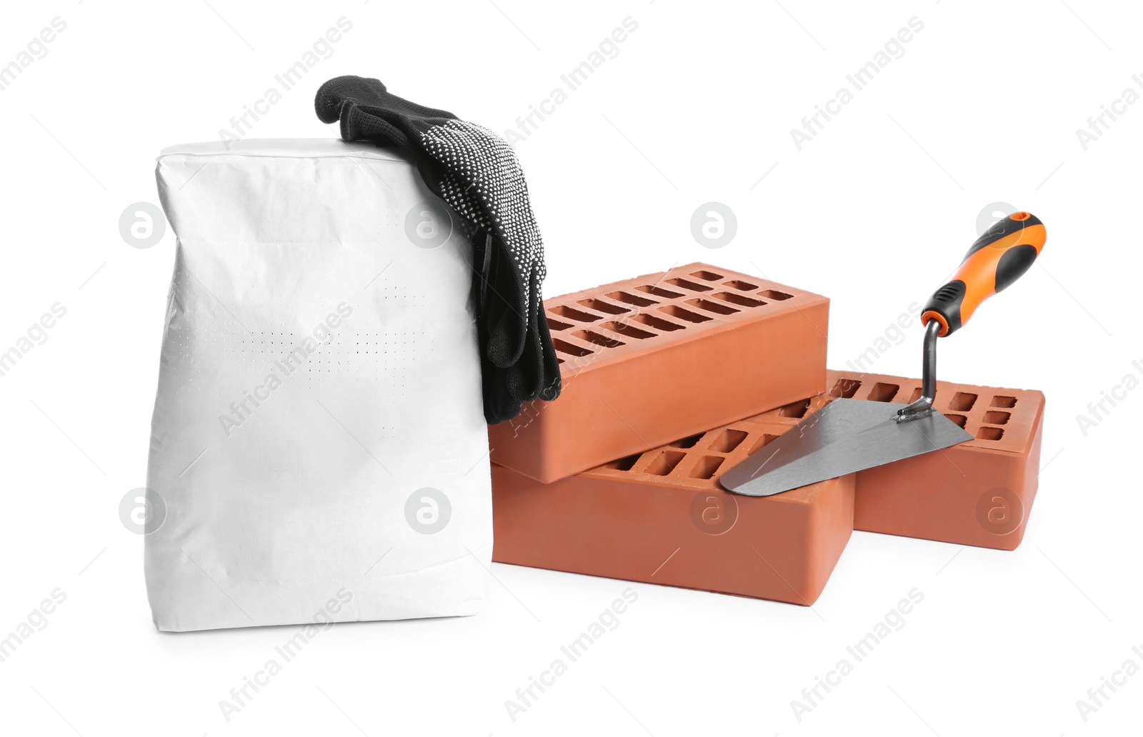 Photo of Red bricks, bag of cement, gloves and trowel on white background