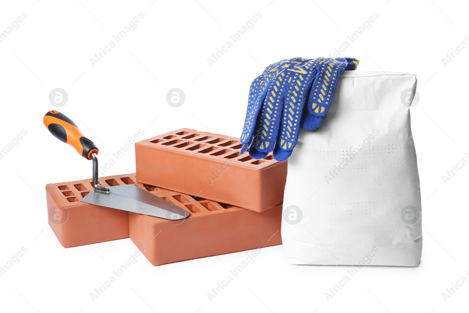 Photo of Red bricks, bag of cement, gloves and trowel on white background