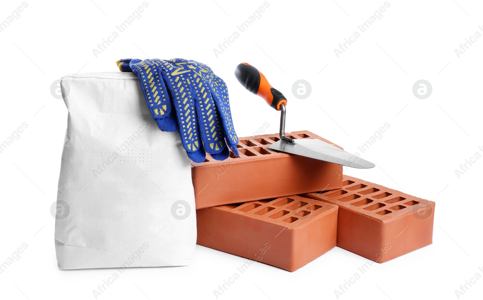 Photo of Red bricks, bag of cement, gloves and trowel on white background