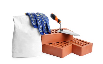 Red bricks, bag of cement, gloves and trowel on white background