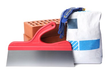 Photo of Bag of cement, bricks, gloves and plastering trowel on white background