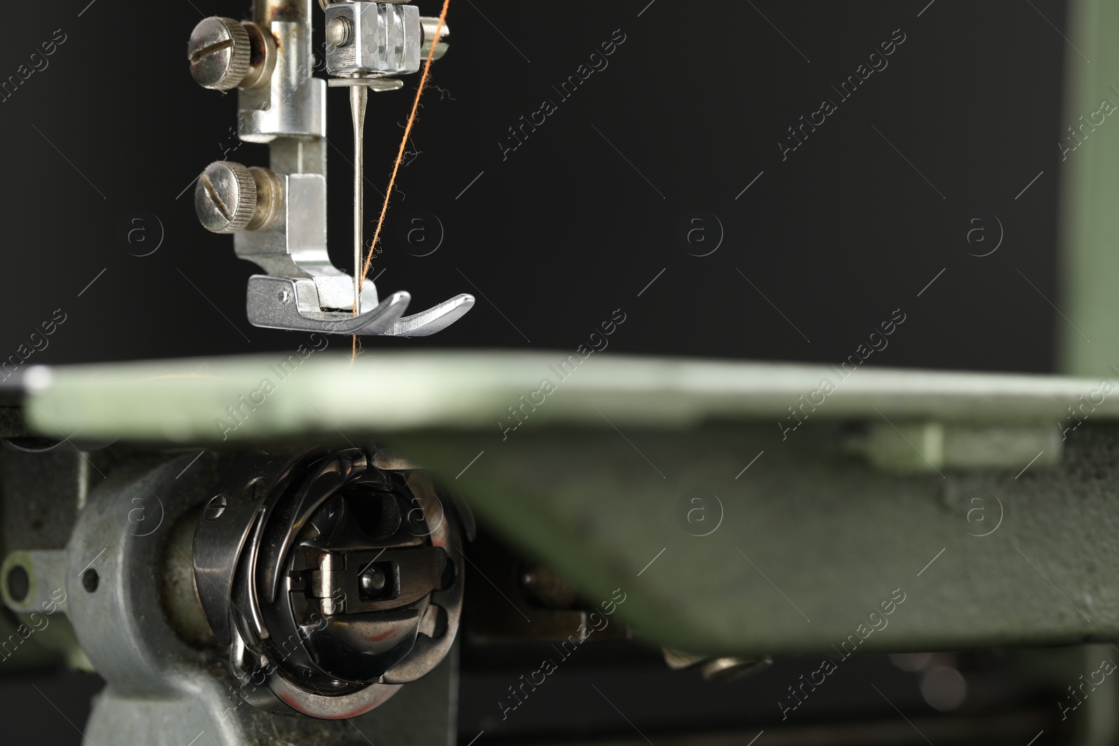 Photo of Professional sewing machine on blurred background, macro view