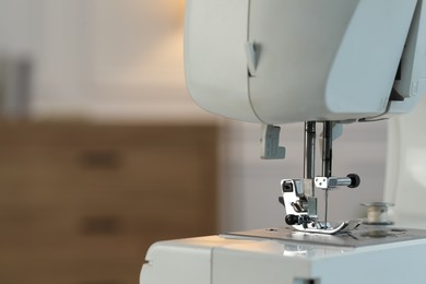 Photo of Sewing machine on blurred background, macro view. Space for text