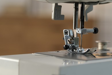 Photo of Sewing machine on blurred background, macro view. Space for text