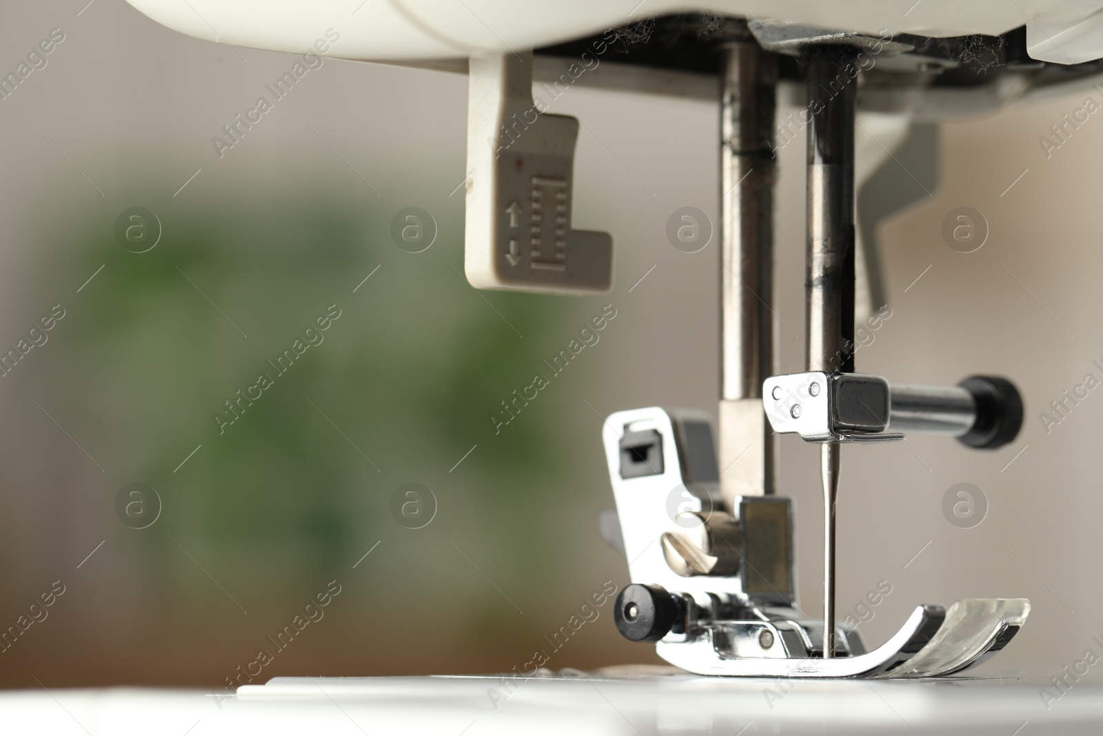 Photo of Sewing machine on blurred background, macro view. Space for text