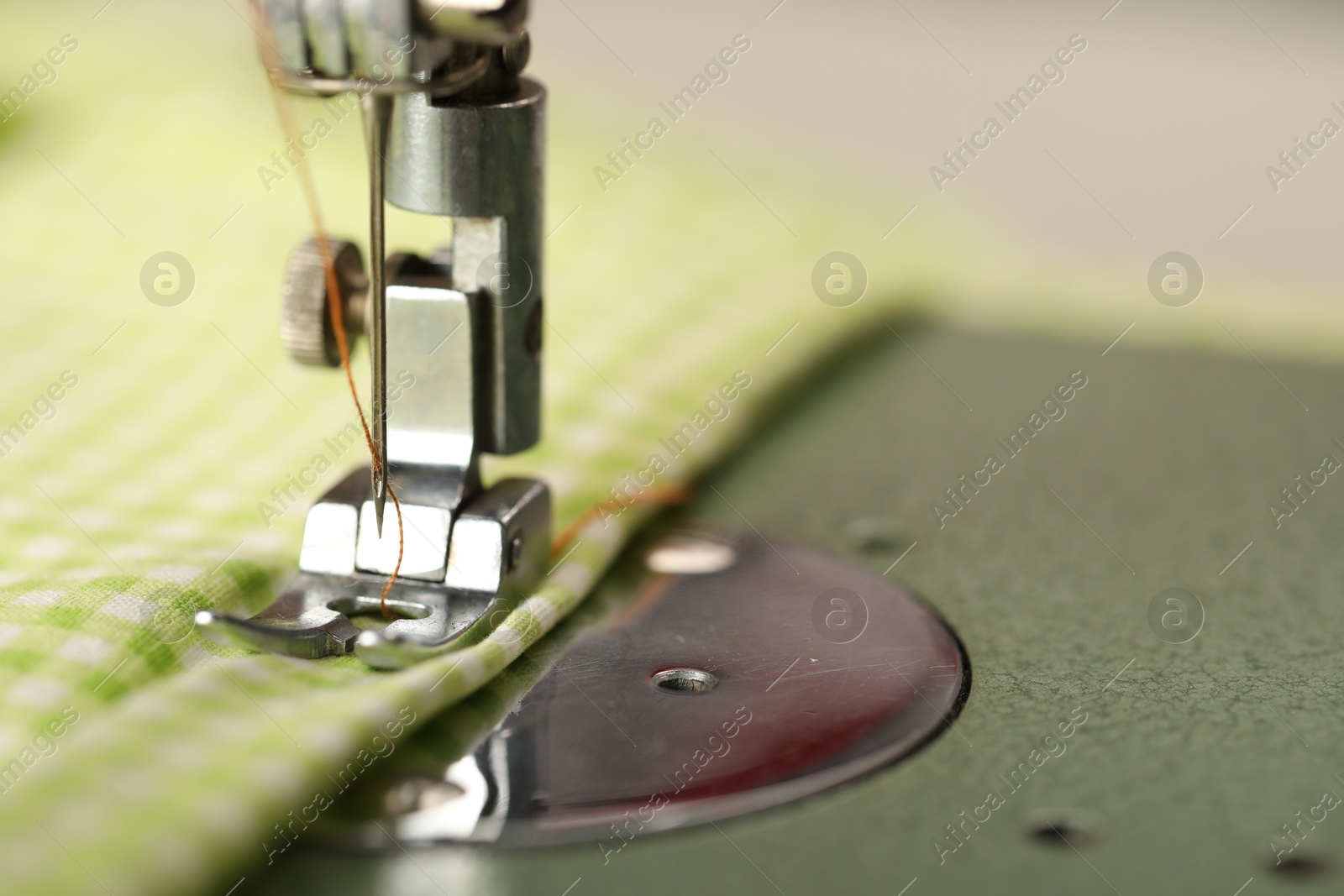 Photo of One sewing machine with thread on blurred background, macro view. Space for text