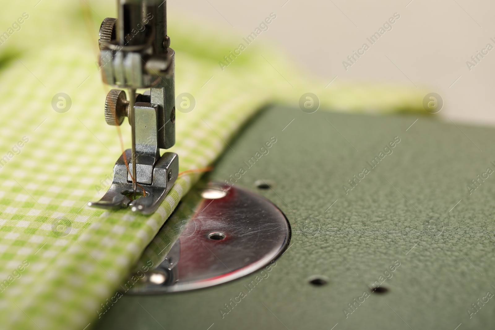 Photo of One sewing machine with thread on blurred background, macro view. Space for text