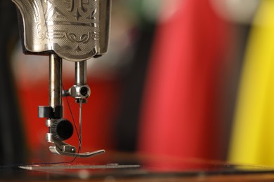 Photo of One vintage sewing machine on blurred background, macro view. Space for text