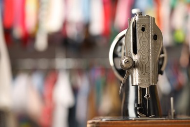 Photo of One vintage sewing machine in workshop, closeup. Space for text