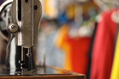 Photo of One vintage sewing machine in workshop, closeup. Space for text