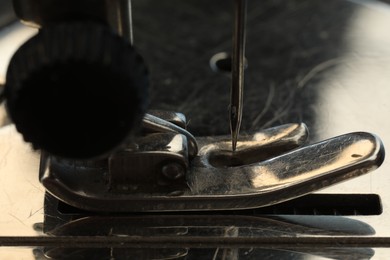 Photo of Macro view of one metal sewing machine