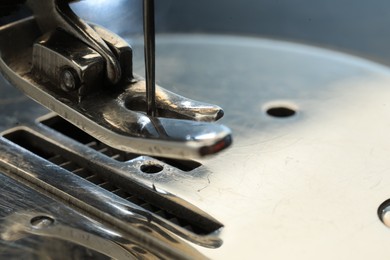 Photo of Sewing machine on color background, macro view. Space for text