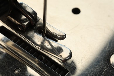 Photo of Macro view of sewing machine, space for text