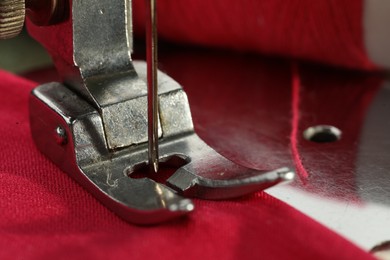 Photo of One sewing machine on color background, macro view