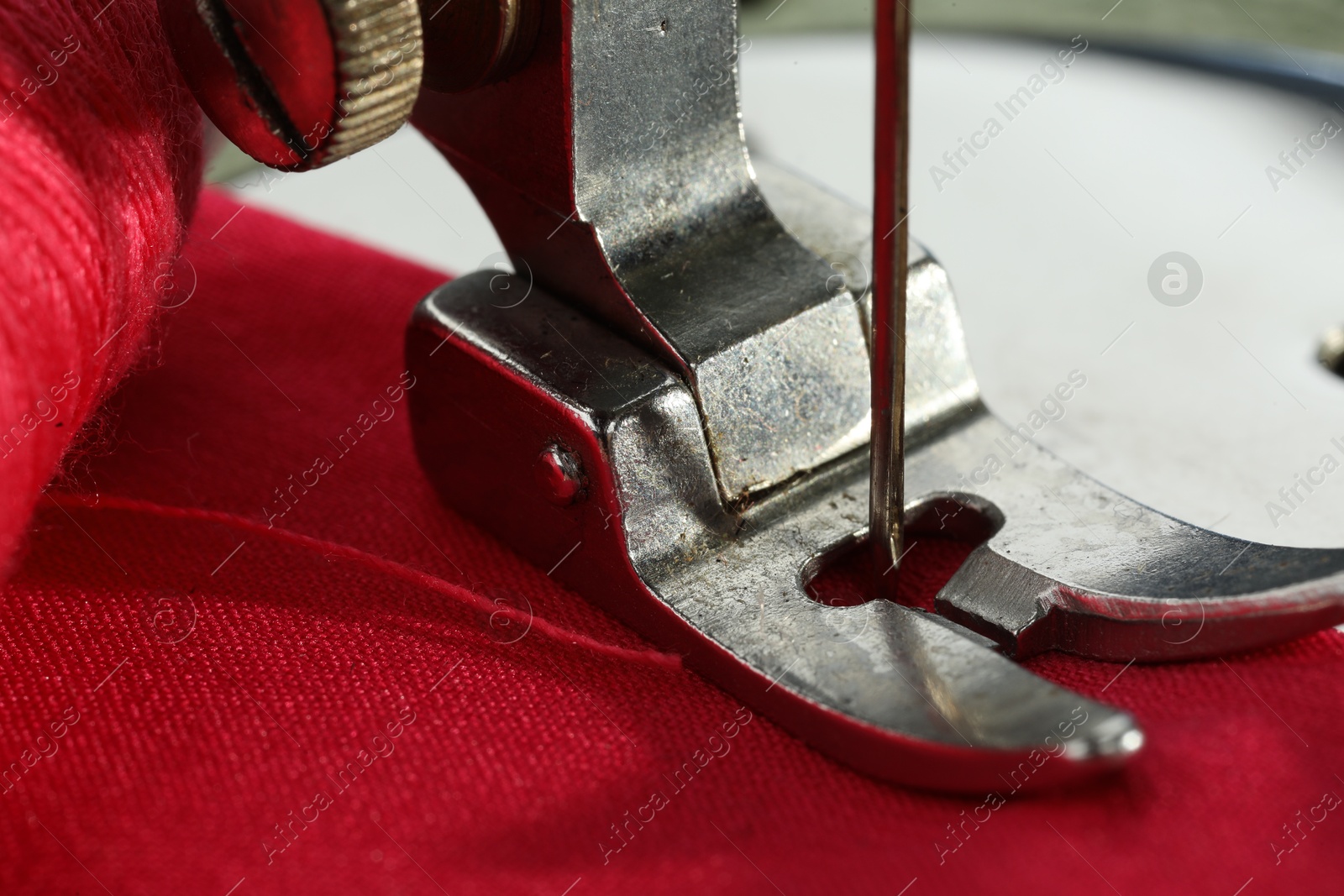 Photo of One sewing machine on color background, macro view