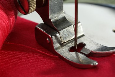 Photo of One sewing machine on color background, macro view