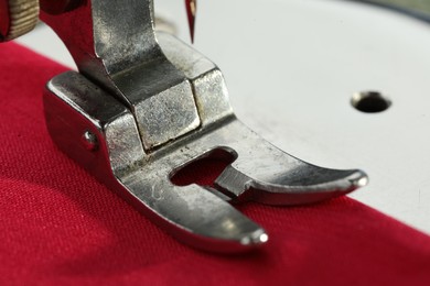 Photo of One sewing machine on color background, macro view