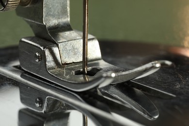 Photo of One sewing machine on color background, macro view