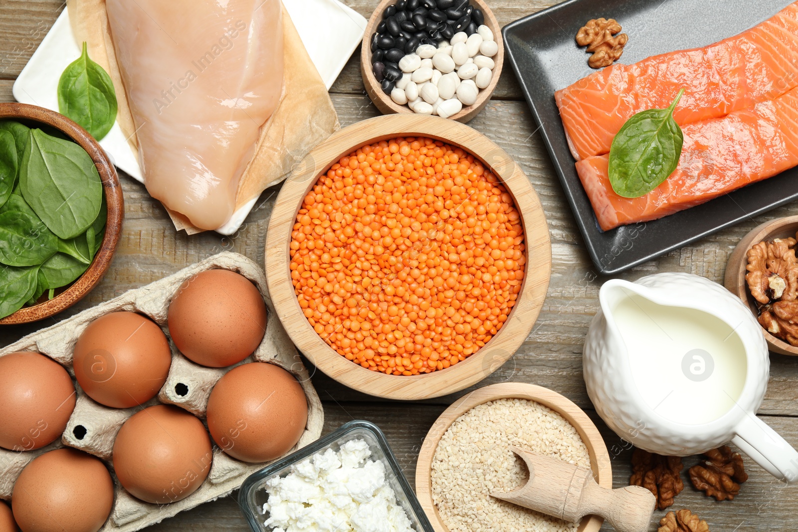 Photo of Different products rich in estrogen on wooden table, flat lay