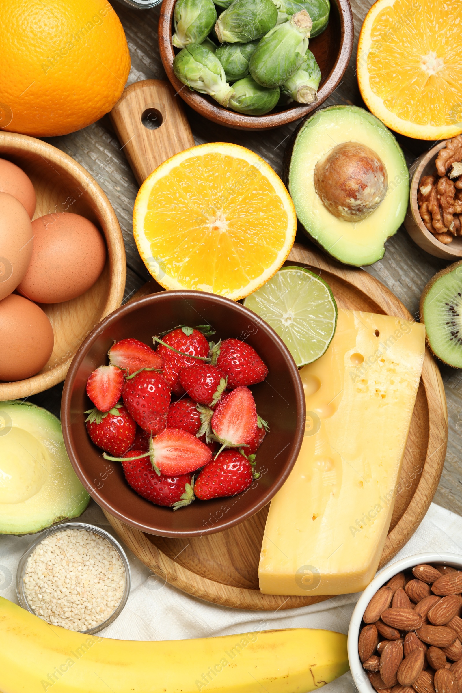 Photo of Different products rich in dopamine on wooden table, flat lay