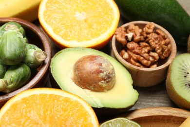 Photo of Different products rich in dopamine on wooden table, closeup