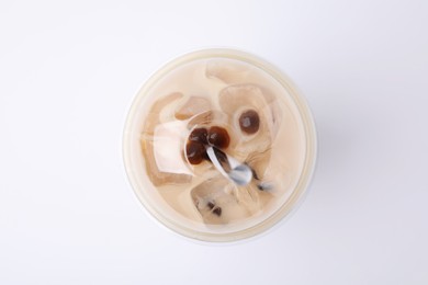 Photo of Tasty milk bubble tea in plastic cup on white background, top view