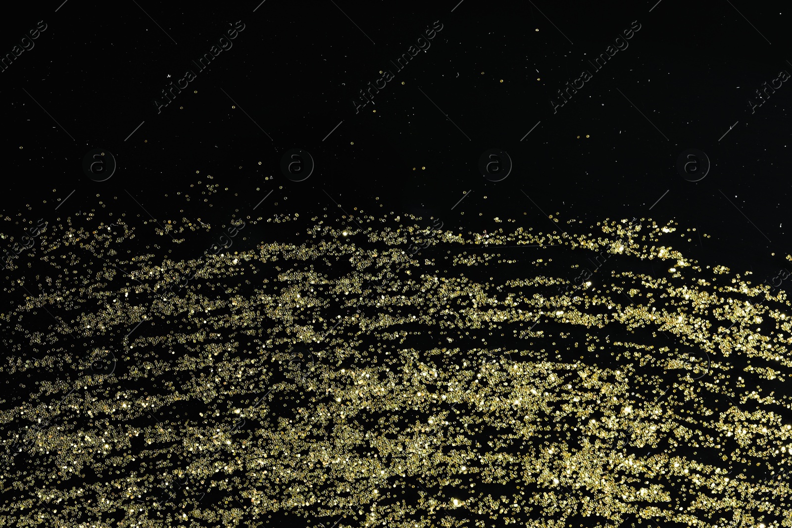 Photo of Beautiful shiny golden glitter on black background, top view