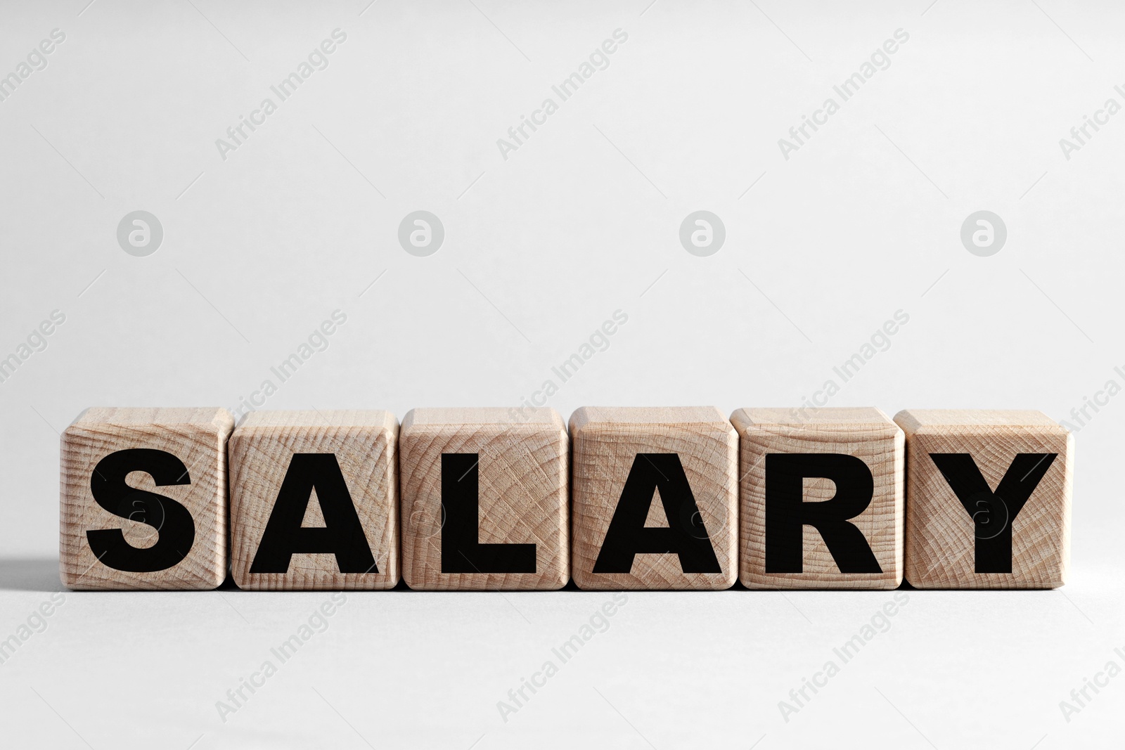 Photo of Word Salary made of cubes on light grey background, space for text