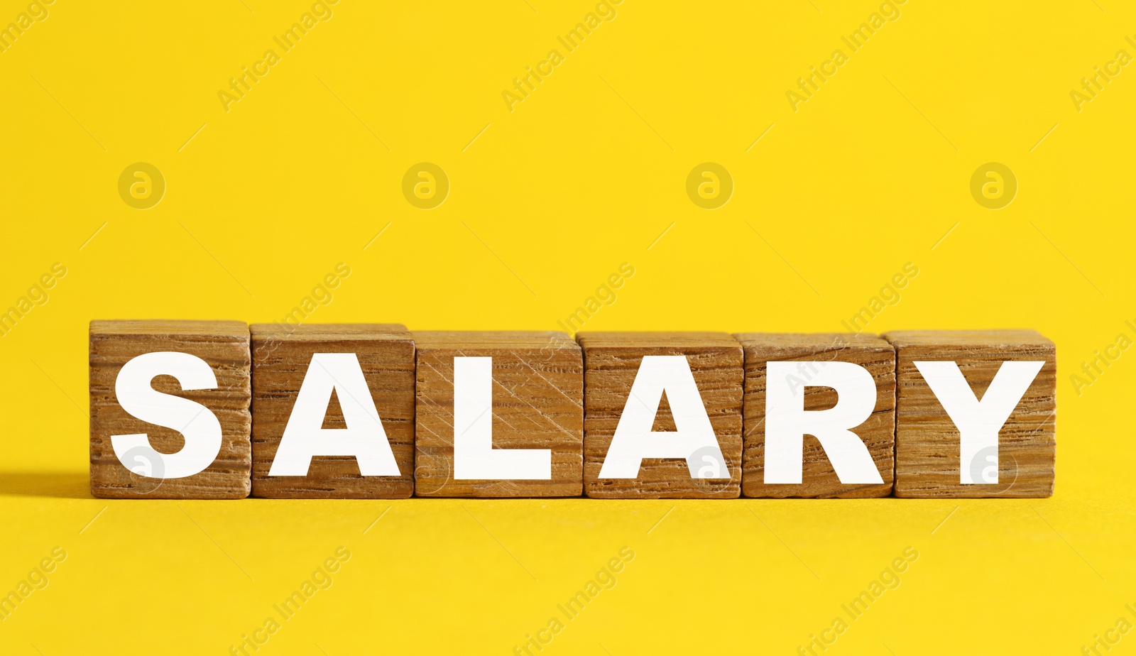 Photo of Blank wooden cubes on yellow background, space for text