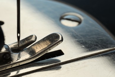 Photo of Sewing machine on dark background, macro view. Space for text