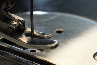 Photo of Sewing machine on color background, macro view. Space for text