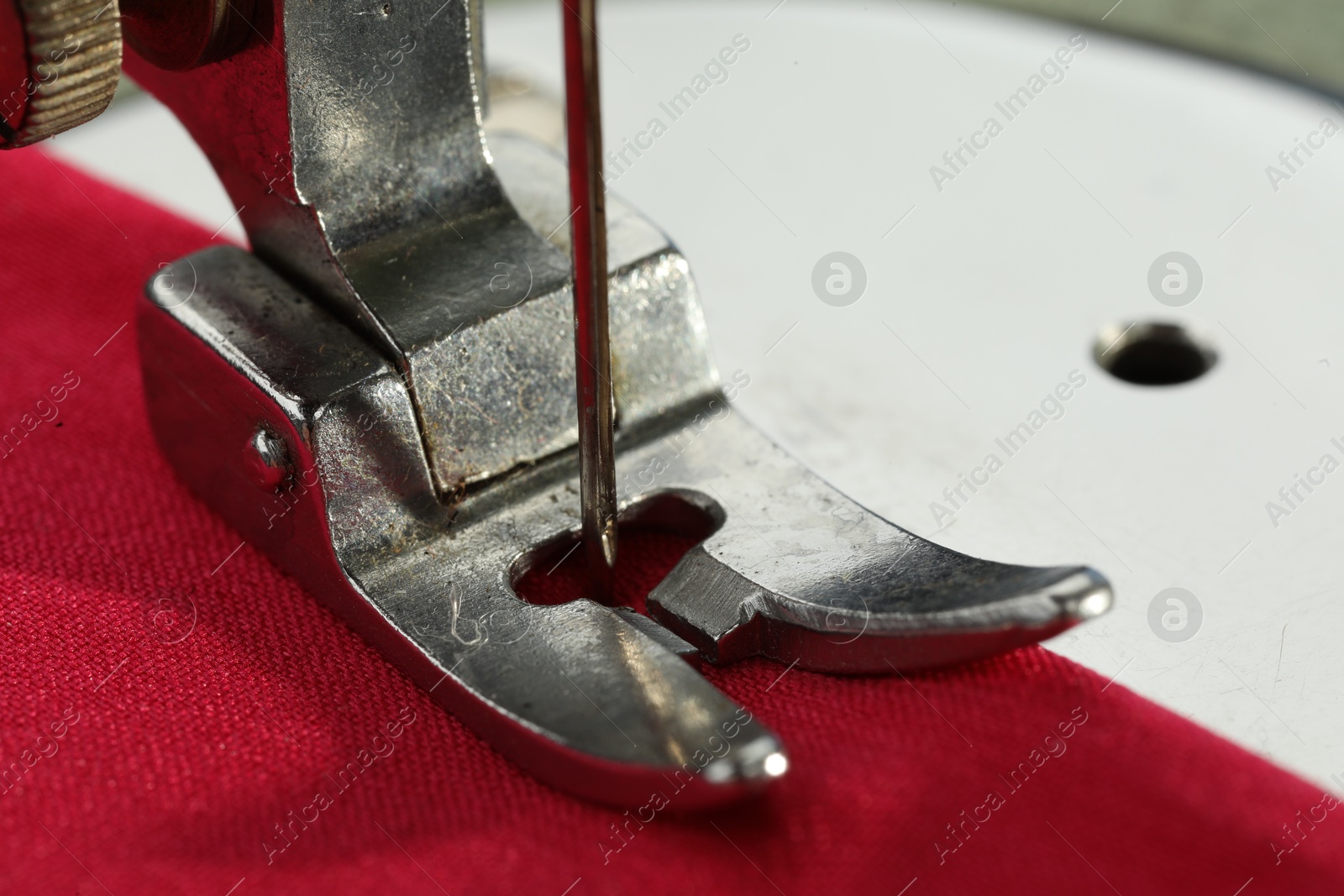 Photo of One sewing machine on color background, macro view