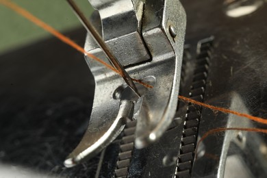 Photo of One sewing machine with thread, macro view