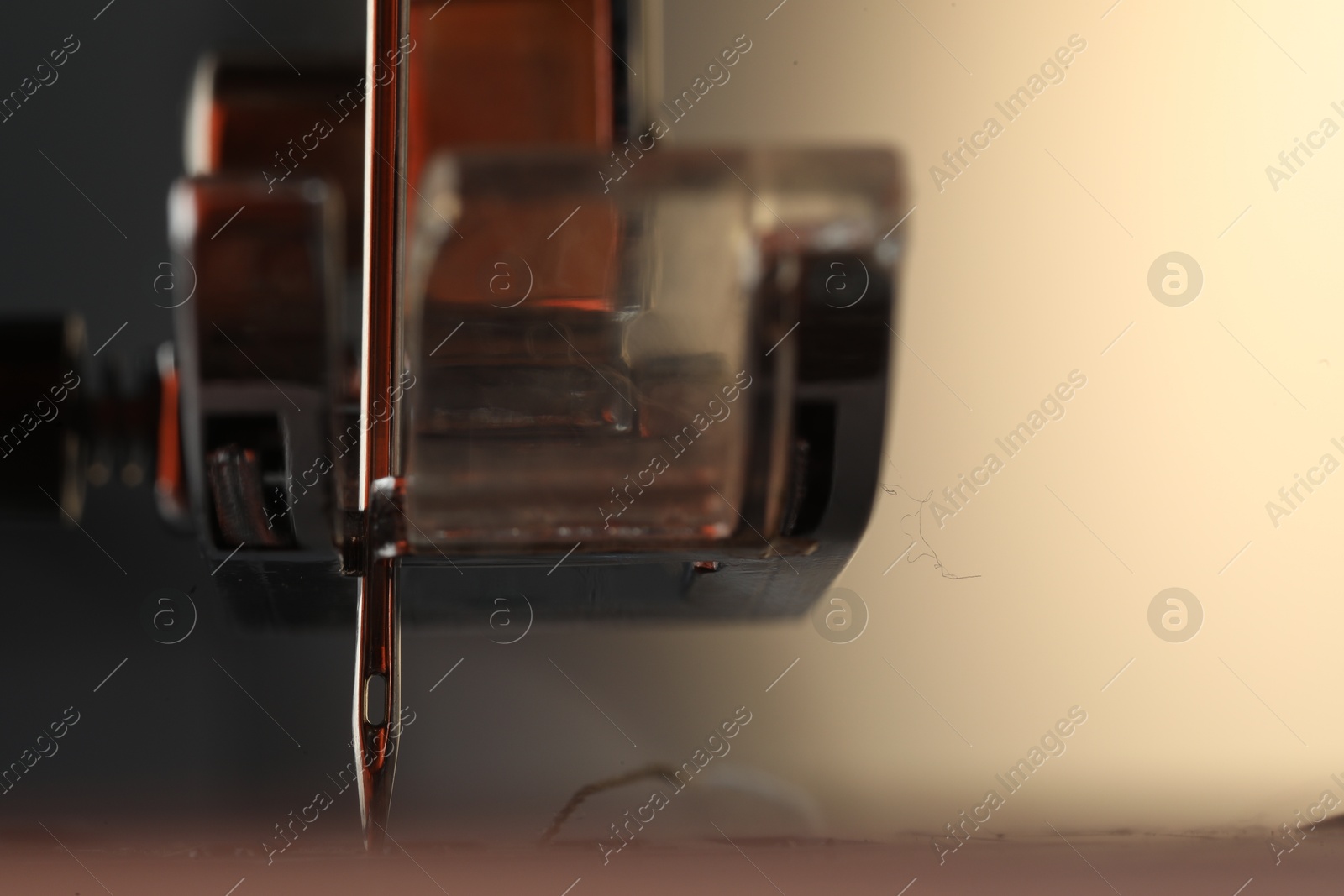 Photo of Sewing machine on light background, macro view. Space for text