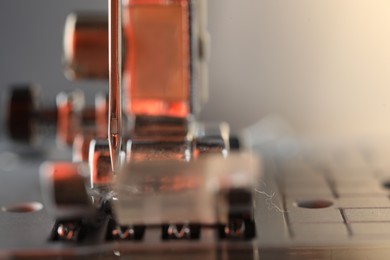 Photo of Sewing machine on light background, macro view