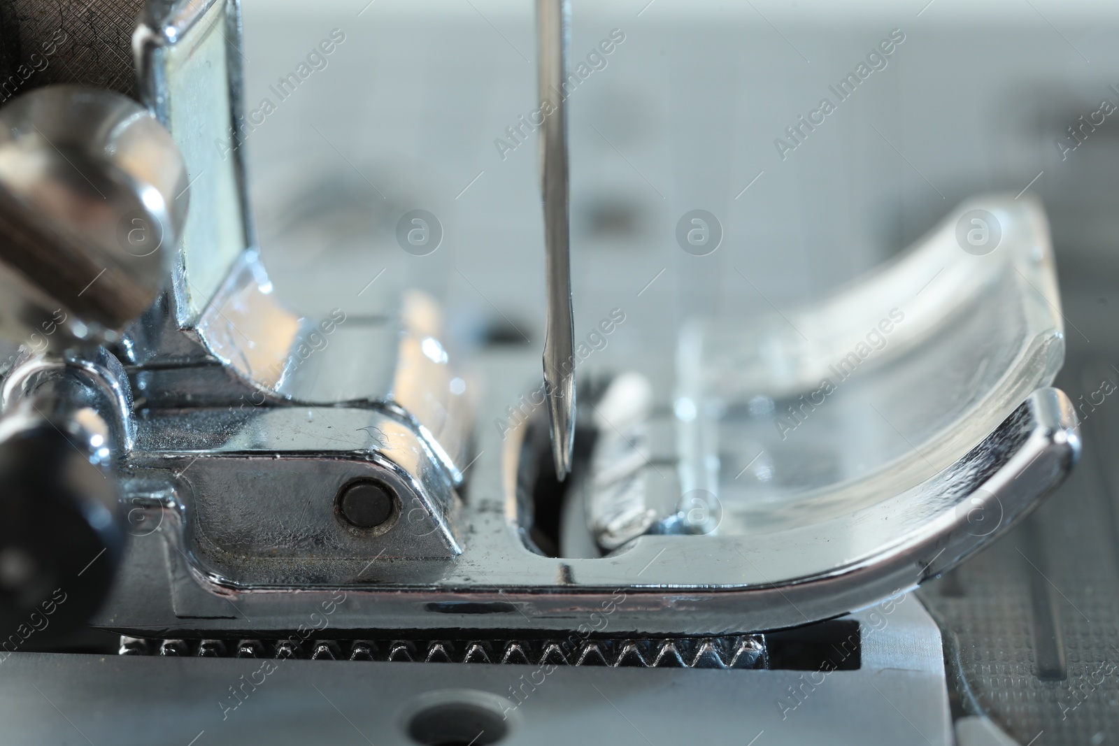 Photo of Sewing machine on light grey background, macro view