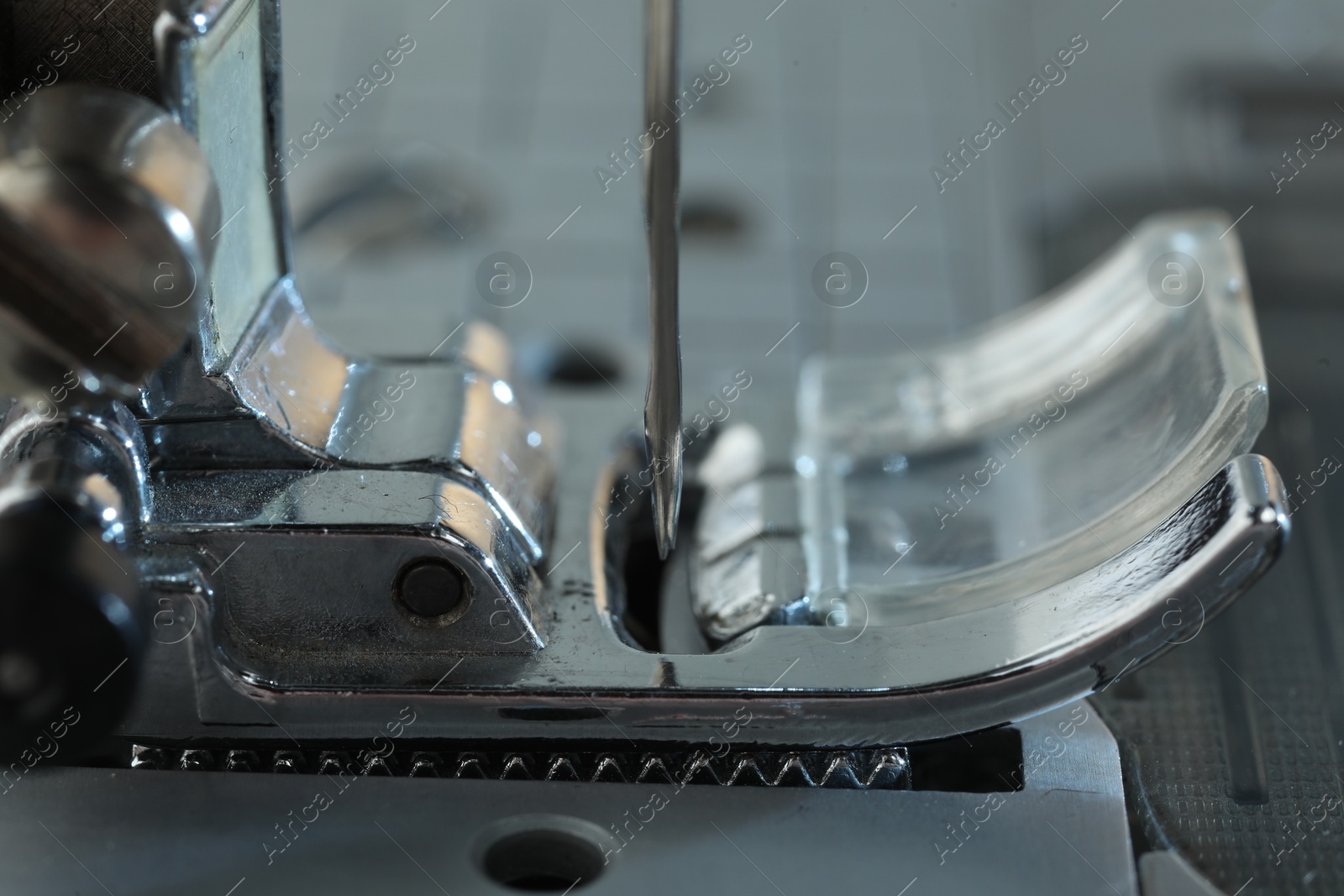 Photo of Sewing machine on light grey background, macro view