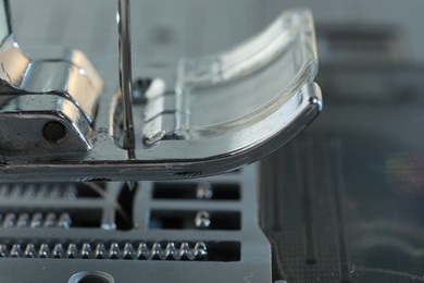 Photo of Sewing machine on light grey background, macro view