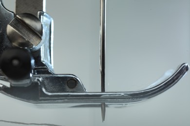 Photo of Sewing machine on light grey background, macro view