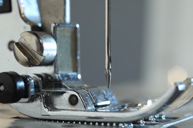 Photo of Sewing machine on light grey background, macro view