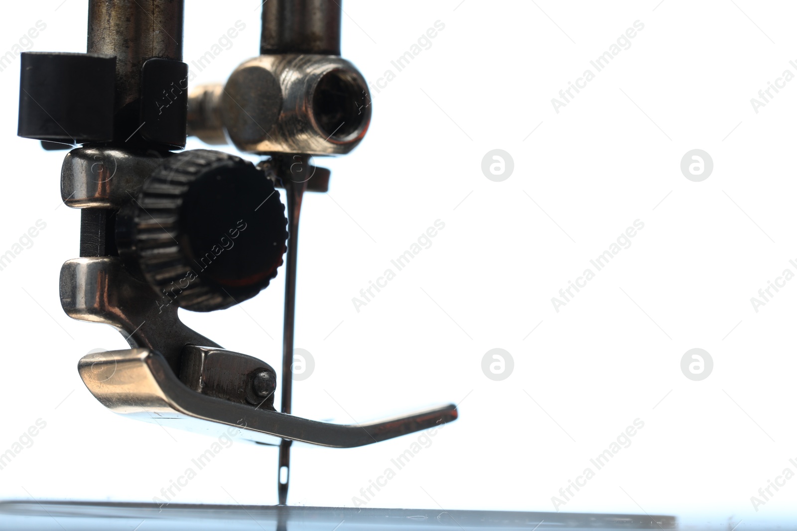 Photo of Sewing machine on white background, macro view. Space for text