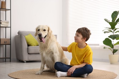 Boy with his cute dog at home