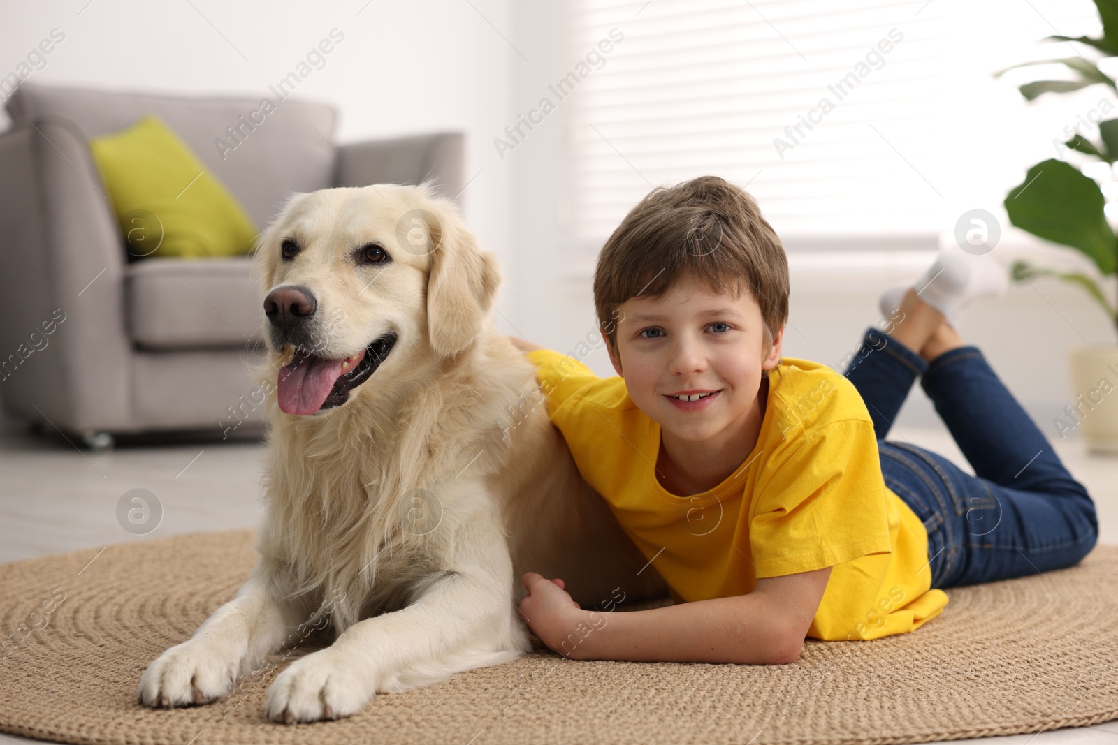 Photo of Boy with his cute dog at home