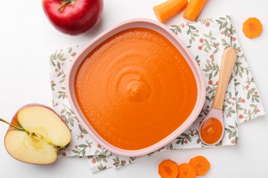 Photo of Delicious baby food in bowl and ingredients on white table, flat lay