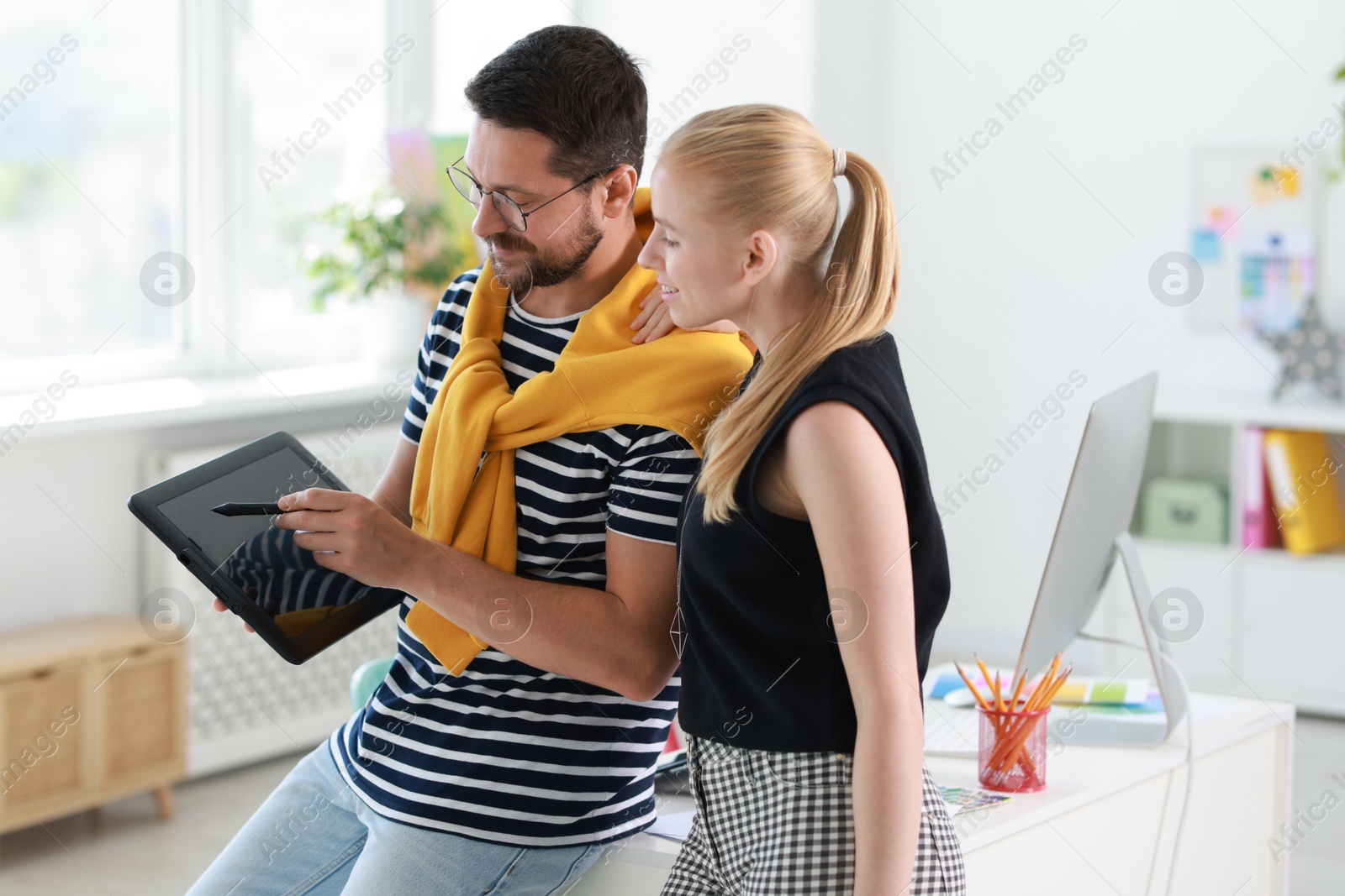 Photo of Designers with tablet working together in office