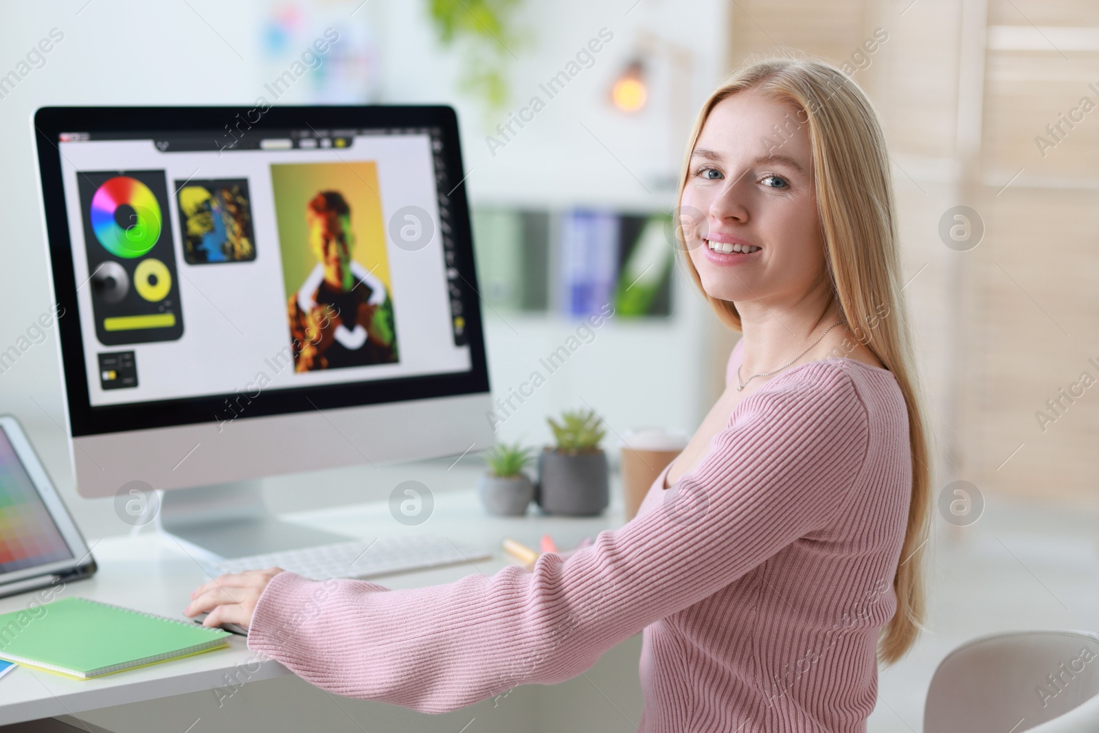 Photo of Graphic designer working with computer at table in office