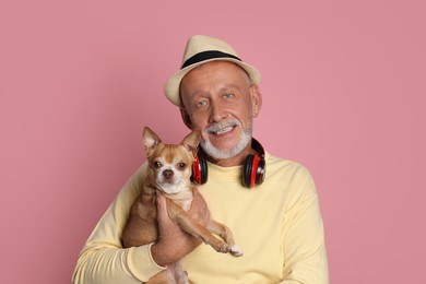 Photo of Portrait of happy senior man with Chihuahua dog on pink background