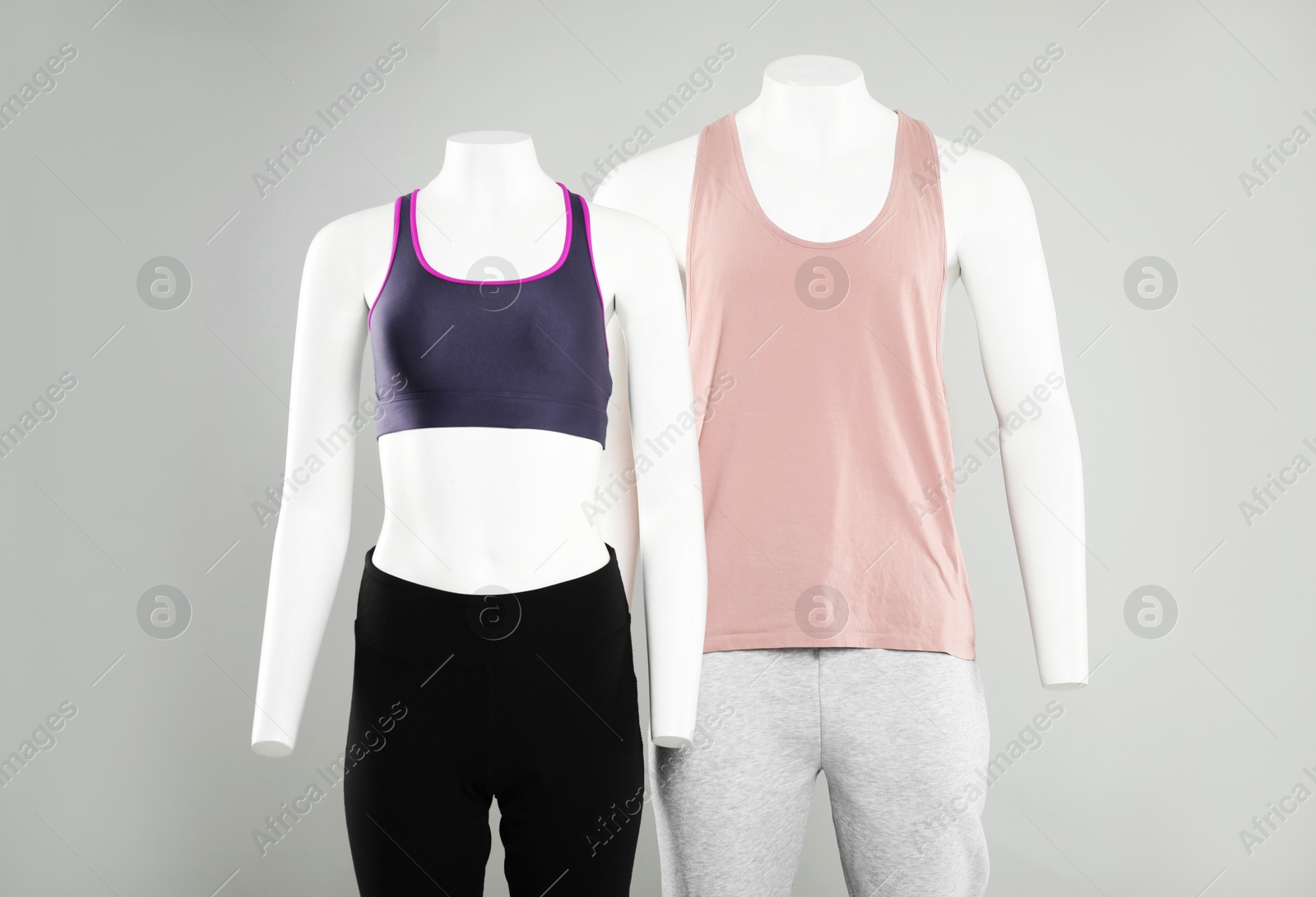 Photo of Female and male mannequins with stylish sportswear on light background