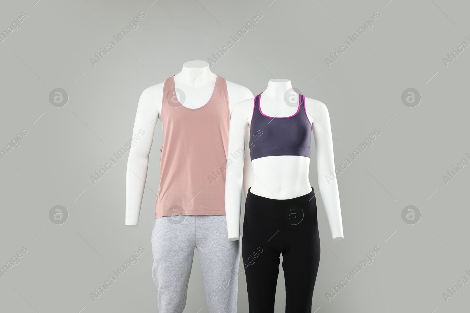 Photo of Female and male mannequins with stylish sportswear on light background